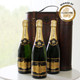Champagne Triple Celebration Gift Box. Three bottles of champagne are displayed on a round white table. The bottles have gold foil caps and black labels, indicating a premium quality. In the background, a decorative wooden box is partially visible. An award seal in the top right corner reads "WINNER OF MUNDUS VINI GOLD." Natural light illuminates the scene, suggesting an elegant setting. Champagne Triple Celebration Gift Box. Three bottles of champagne are displayed on a round white table. The bottles have gold foil caps and black labels, indicating a premium quality. In the background, a decorative wooden box is partially visible. An award seal in the top right corner reads "WINNER OF MUNDUS VINI GOLD." Natural light illuminates the scene, suggesting an elegant setting.